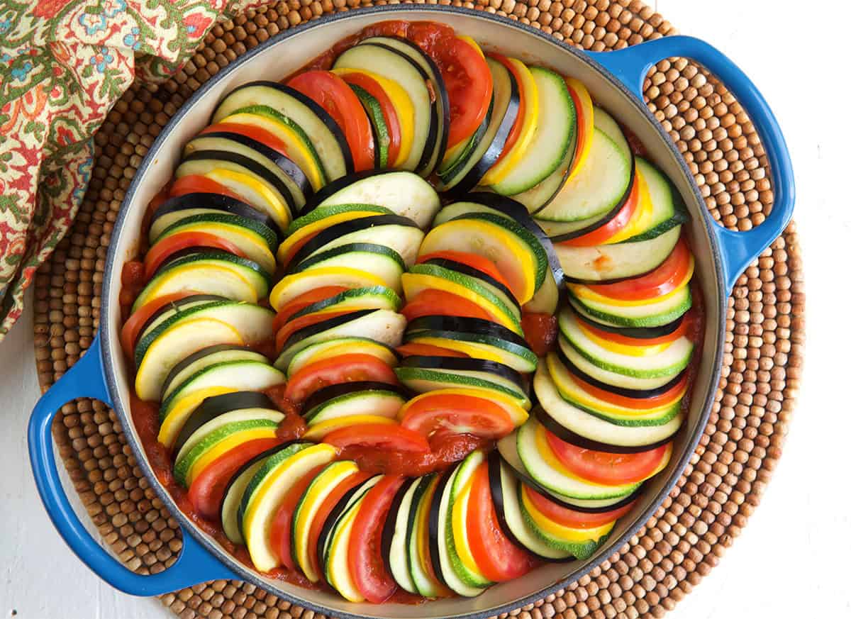 ratatouille arranged in a baking dish before being baked