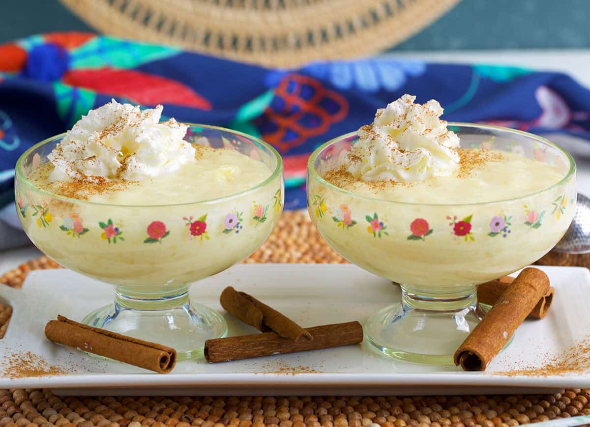 Tapioca pudding in two compote dishes on a white platter