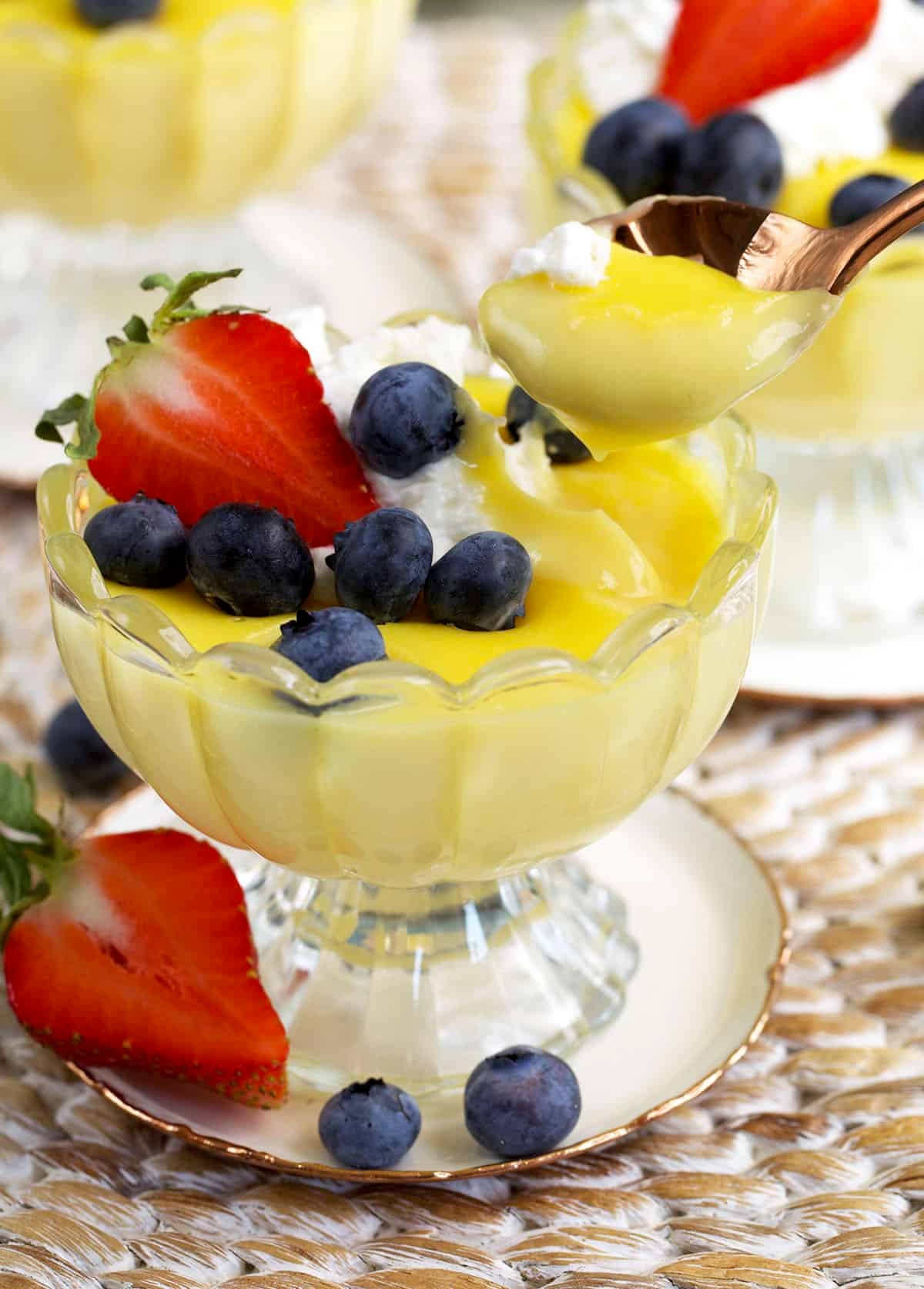 a spoonful of egg custard above a dessert dish.