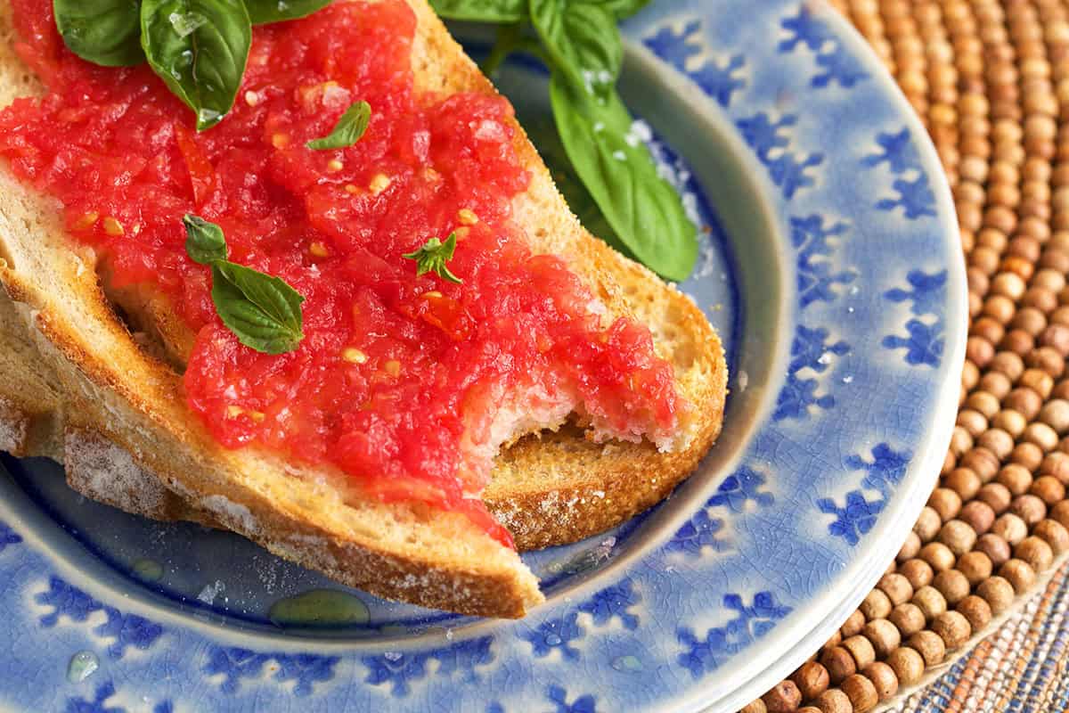 pan con tomate with a bite taken out of it.