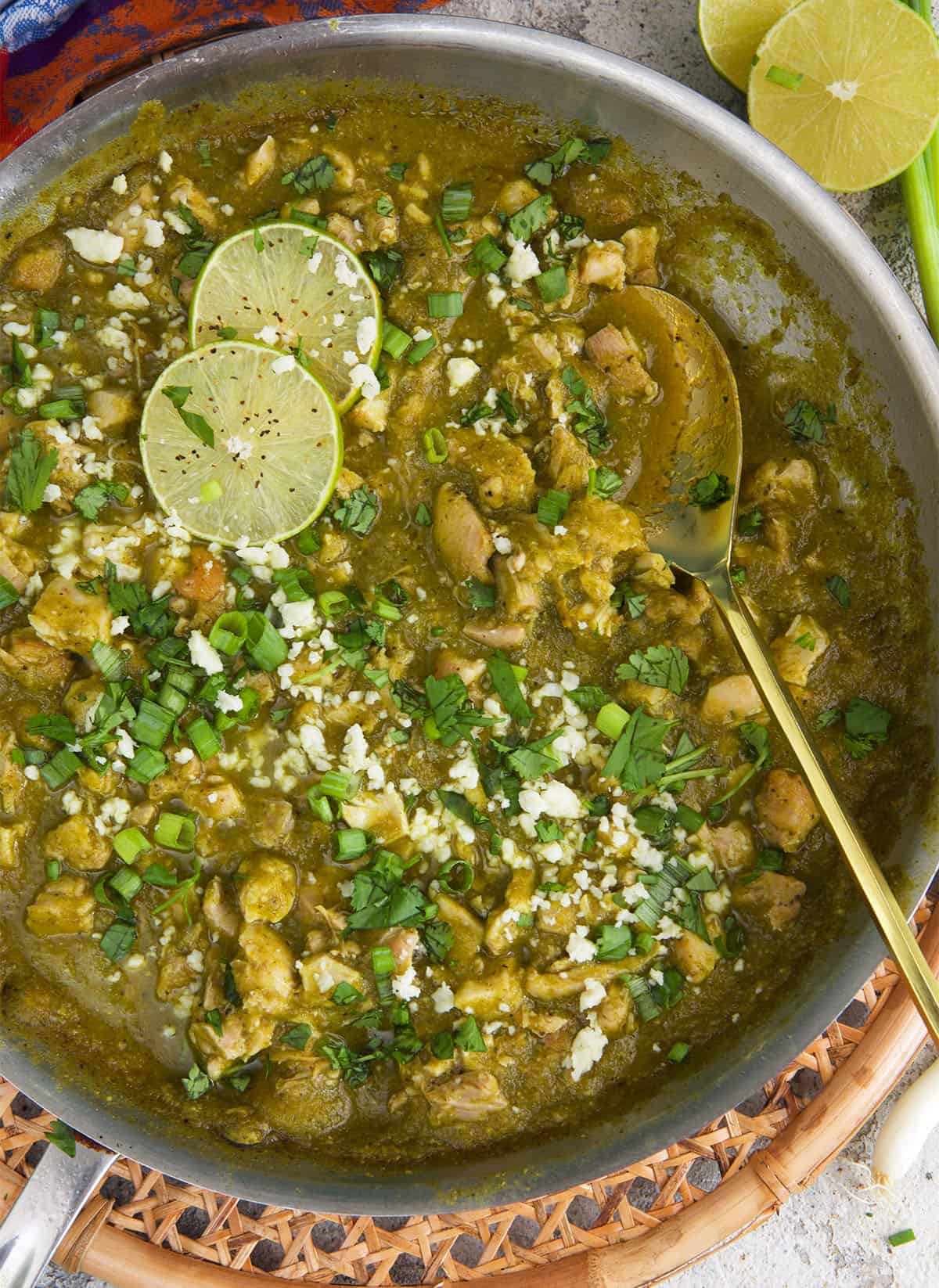 Chicken Chile Verde in a skillet with a serving spoon.