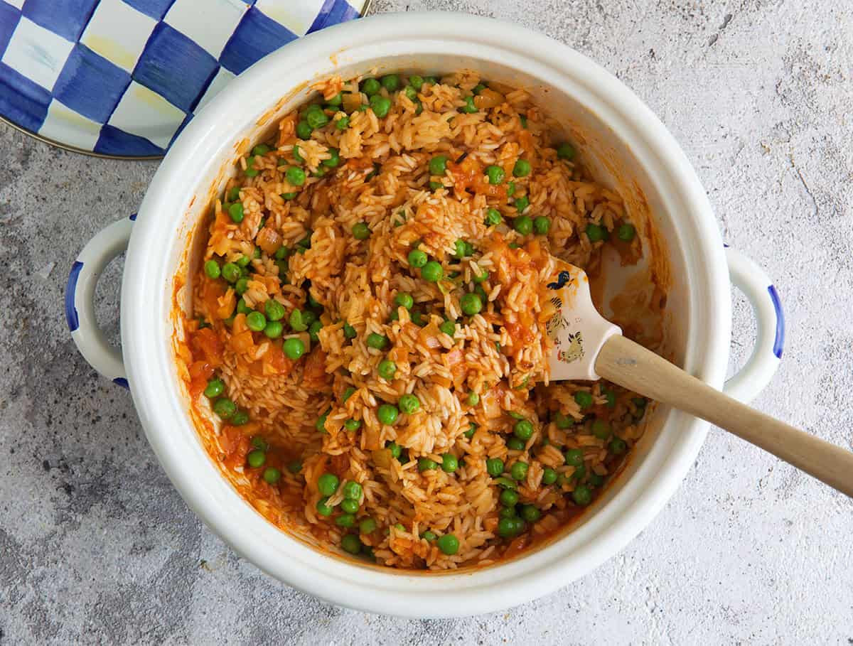 Mexican rice being made in a white pot.