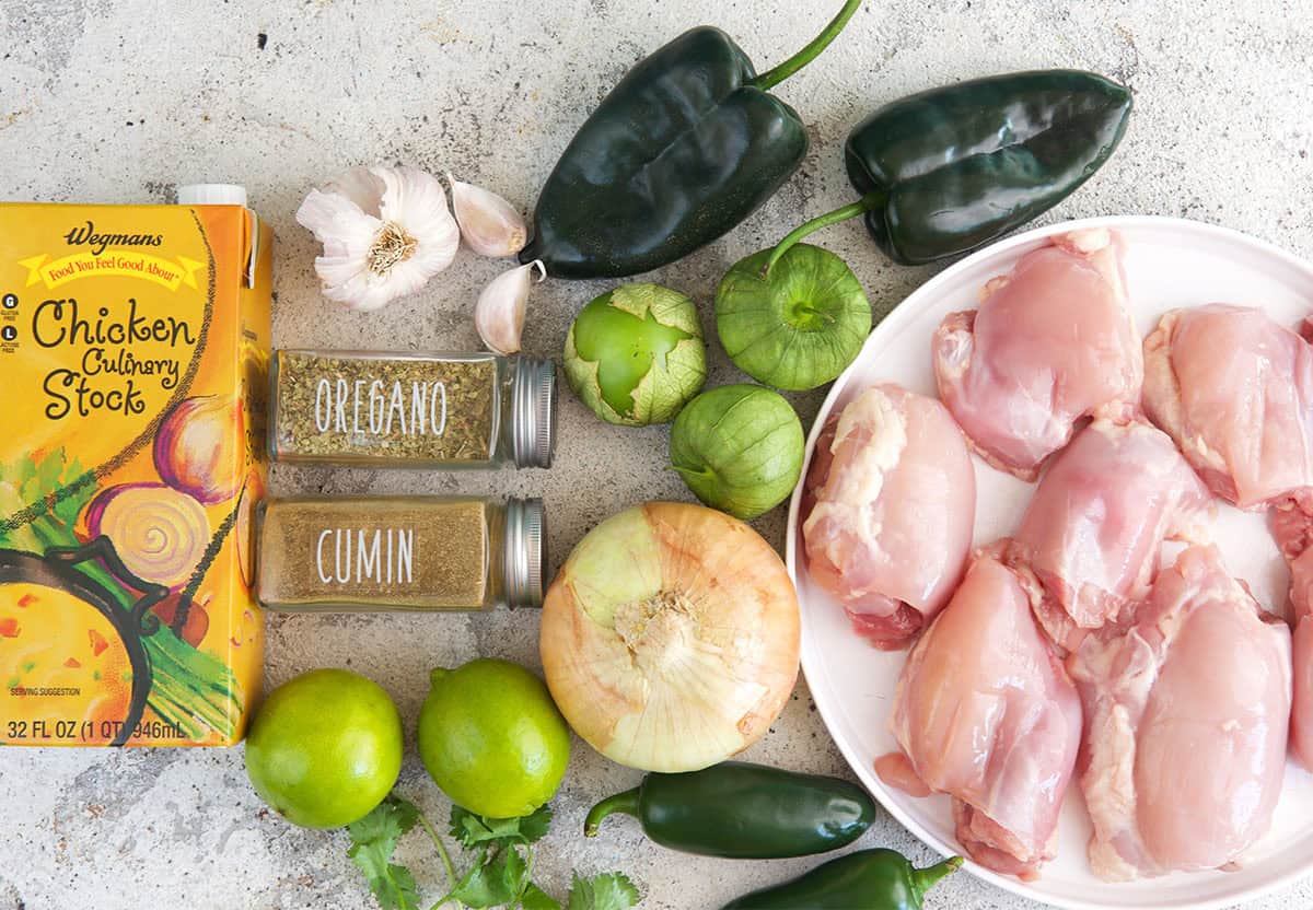 chicken Chile verde ingredients, chicken thighs, poblano peppers, tomatillos, stock, spices and garlic.