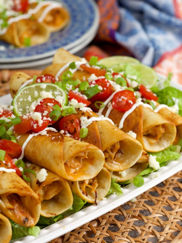 chicken flauta recipe stacked on a platter for serving.