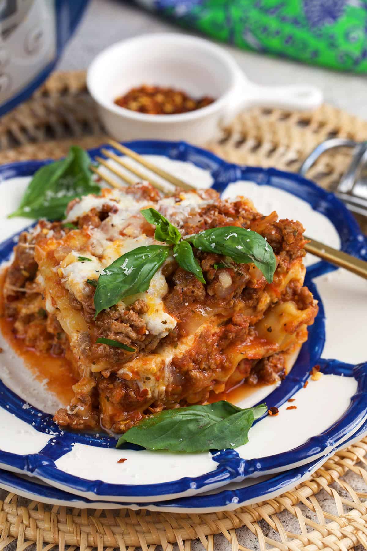 Slice of Crockpot Lasagna on a plate with layers of meat sauce, ricotta and melted mozzarella.