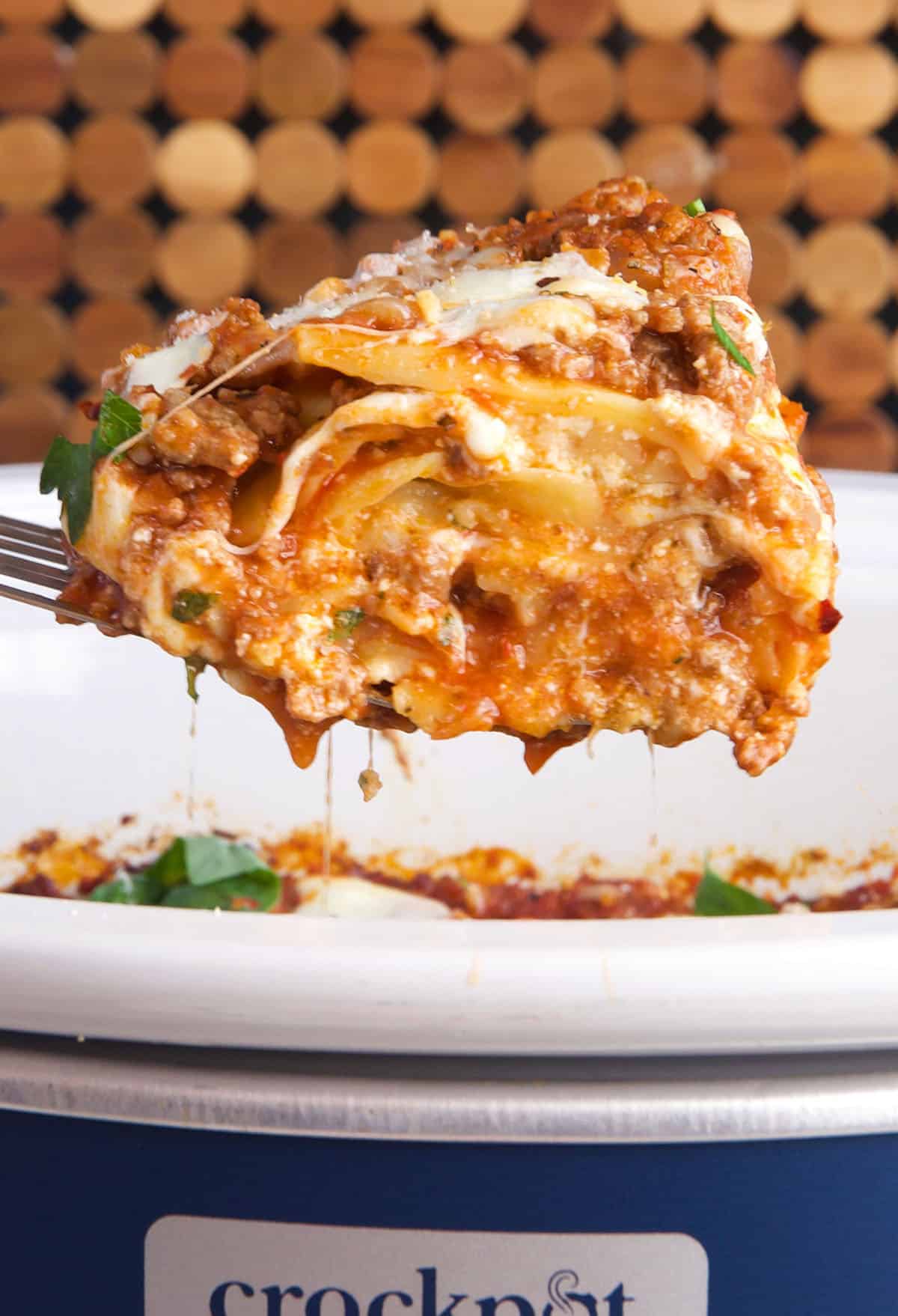 slice of slow cooker lasagna being served with a spatula