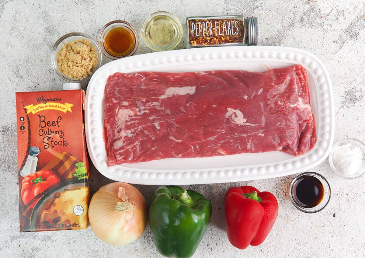 Pepper steak ingredients on a gray surface