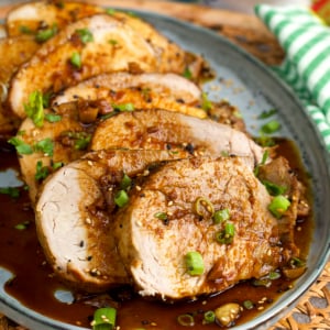 slow cooker pork loin sliced and arranged on a platter.