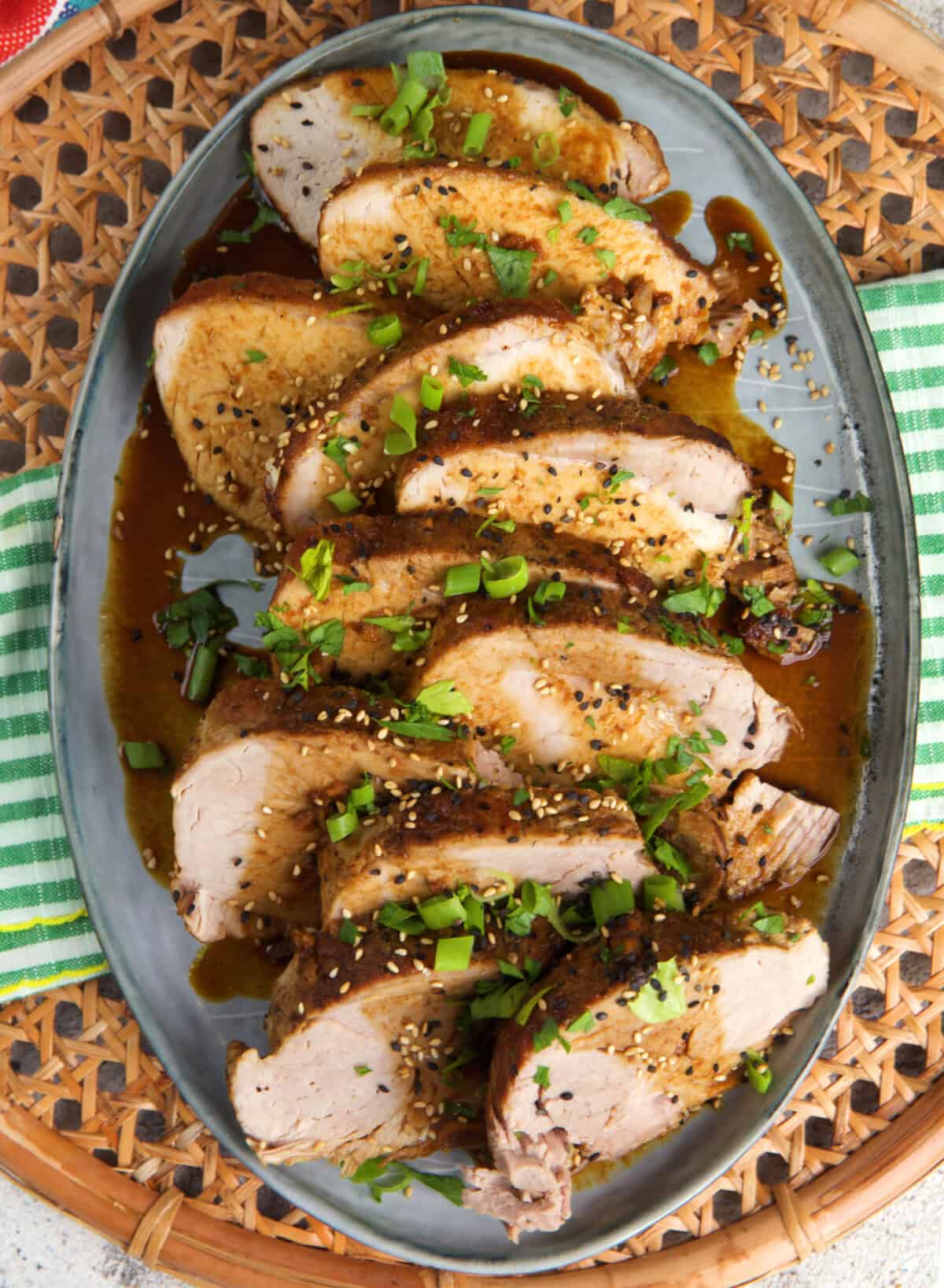 sliced pork loin on a platter with honey garlic sauce