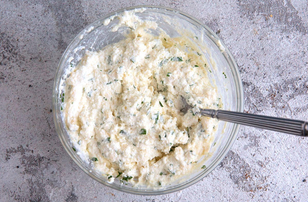 ricotta filling for crockpot lasagna being mixed in a bowl